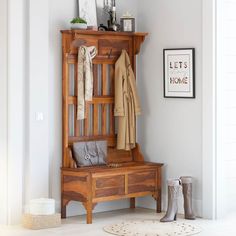 a wooden bench and coat rack in a room