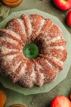 an apple cider bundt cake with powdered sugar on top