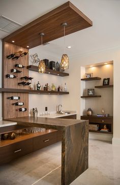 a wine rack in the middle of a room with bottles on it and shelves above