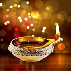 a lit candle in a bowl on a table