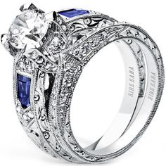 an intricately designed engagement ring set with blue sapphire stones and diamond accents on the sides