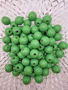 there are many green beads in the bowl