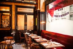 an empty restaurant with wooden tables and chairs