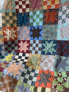 a quilt made with many different colors and patterns