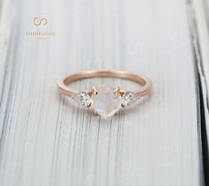 a rose cut diamond ring on top of a wooden table