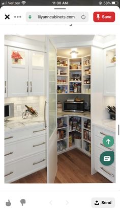 an open pantry with white cabinets and drawers