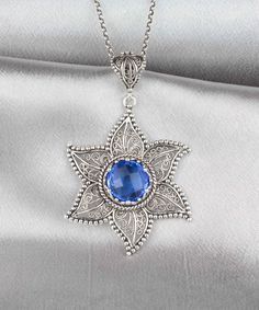 Elevate your style with this stunning handcrafted Sterling Silver Filigree Art Blue Quartz Gemstone Women's Pendant Necklace. The intricate filigree design is crafted from high-quality 925 sterling silver, while the mesmerizing blue quartz gemstone adds a touch of sophistication to this standout piece. Expertly crafted by skilled artisans, this pendant necklace is a true work of art that is perfect for any occasion. Whether you're dressing up for a special event or adding a touch of elegance to Blue Star-shaped Bohemian Jewelry, Blue Star Of David Jewelry Gift, Handmade Elegant Star Of David Jewelry, Gift Jewelry With Sapphire Filigree, Elegant Blue Star-shaped Jewelry, Blue Filigree Pendant Jewelry, Blue Star-shaped Gemstone Necklace, Blue Gemstone Star Of David Jewelry, Blue Star Of David Gemstone Jewelry