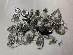 This is a 1/2 pound lot of broken and not, vintage and newer craft jewelry. The majority of these are wearable or for craft Silver tones There are necklaces, earrings, bracelets, key rings, broken pieces etc etc. Both vintage and modern. Perfect for your slow stitches or scrapbooking projects. Or other works of art This is NOT a mystery bag or box, so there will be no surprises You get everything in the picture. So study the pictures carefully !! Various materials such as plastic, metal, beads, Collectible Round Costume Jewelry, Silver Jewelry With Lost Wax Casting For Jewelry Making, Unique Party Jewelry With Charms, Nickel-free Assorted Jewelry Gift, Elegant Assorted Jewelry For Gift, Vintage Charms For Crafting Jewelry, Vintage Handmade Assorted Jewelry, Assorted Jewelry Making Supplies, Assorted Vintage Handmade Jewelry