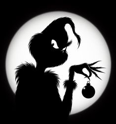 a black and white silhouette of a cat holding a christmas ornament in front of a full moon