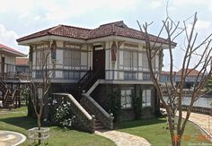 an old house with stairs leading up to it