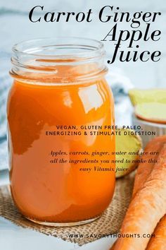 a jar of carrot ginger apple juice next to fresh carrots