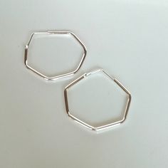 These are minimalist and hexagon shaped sterling silver hoops. Dimensions: 2mm X 25mm Weight: 2.8 gm Price listed is for a PAIR of hoops. These earrings are made of 925 hypoallergenic sterling silver and comes with a 925 stamp. Can be packaged in a gift box. I can include a personal message from you if needed You are welcome to contact me at... bhavnakwintra1956@gmail.com For more beautiful pieces from my shop, please browse 👇 TOE RINGS: https://www.etsy.com/your/shops/TheSilverGame/tools/listi Minimalist Octagon Jewelry For Everyday, Minimalist Everyday Octagon Jewelry, Minimalist Hexagon Hoop Earrings For Gifts, Minimalist Hexagon Hoop Earrings Gift, Hoops Silver, Hoop Earrings Silver, Jewelry Minimalist, Small Faces, Silver Accessories