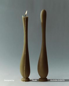 there are two candles in the shape of vases