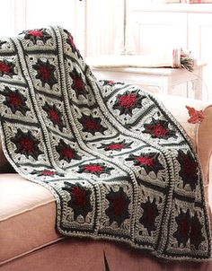 a crocheted afghan is sitting on a couch