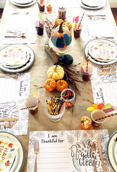 a table set for thanksgiving dinner with place settings