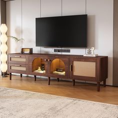 a large flat screen tv mounted on top of a wooden entertainment center in a living room