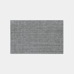 a gray area rug on a white background