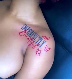 a woman's breast with the word identity tattooed on her left side and butterflies around it