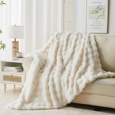 a large white blanket sitting on top of a couch