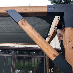 a wooden structure with metal straps on it's sides and an awning over the top