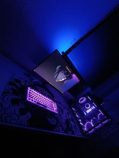 a computer keyboard sitting on top of a desk next to a monitor screen and mouse pad