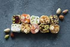 assorted sweets arranged on top of each other with nuts and dried fruit in the middle