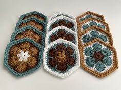 four crocheted dishcloths sitting on top of a table