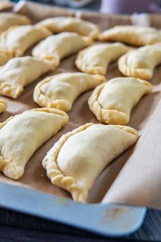 several pastries on a baking sheet ready to be baked in the oven for consumption