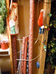 a shelf filled with lots of christmas wrappings and other holiday decorations on top of it