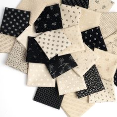 a pile of black and white napkins sitting on top of each other next to each other