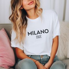 Indulge in the allure of Milano, Italy with our Milano T-shirt. This classic unisex jersey short sleeve tee, designed to fit like a well-loved favorite, brings together soft, high-quality cotton and an exquisite print that will make you fall in love time and again. With ribbed knit collars enhancing its shape, tapered shoulders for a comfortable fit, and dual side seams to maintain its form, this shirt is a must for your Italy vacation trip or to infuse your wardrobe with trendy Italian fashion. Milano Shirt Outfit, Italian T Shirt Design, Italy Football Shirt, Italia Shirt, Italy Shirt, Italian Shirts, Fashion Bella, Love Time, Milano Italy