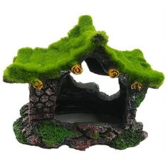 a small green house with moss growing on the roof