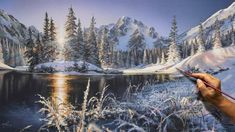 a person is painting a snowy mountain scene