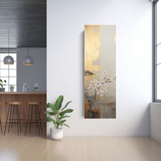 an abstract painting hangs on the wall next to a potted plant and bar stools