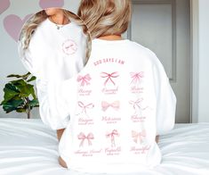 "Elevate your style with our Christian Pink Bow Balletcore Coquette Sweatshirt, a perfect fusion of fashion and faith. Adorned with a dainty pink bows, this sweatshirt exudes grace, while the small print on the front, \"God is within her, she will not fail,\" provides a daily dose of strength. The impactful large print on the back features empowering affirmations derived from various Bible verses, reminding you that you are Strong, Enough, Brave, Unique, Victorious, Chosen, Always Loved, Capable, and Beautiful. Crafted with purpose, this sweatshirt is a wearable affirmation of your spiritual journey, symbolizing the perfect blend of style, empowerment, and divine inspiration. * Q U I C K * F A C T S * ✺ 100% preshrunk cotton ✺ Wash (inside out) and dry normally (on cool for best results) * Inspirational Pink Crew Neck Top, Inspirational Long Sleeve Relaxed Fit Top, Inspirational Relaxed Fit Long Sleeve Top, Coquette Clothing, Christian Crewneck, Coquette Top, Sweater Tshirt, Christian Sweatshirt, Pink Bows