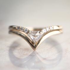 a diamond ring is shown on a white surface