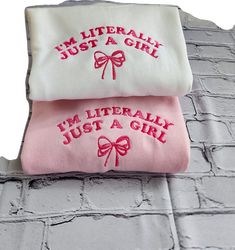 Cute Embroidered Sweatshirt Gift, Cute White Embroidered Sweater, Cute White Embroidered Sweatshirt, Cute Winter Tops With Embroidered Text, Cute Embroidered Winter Tops, Pink Cotton Sweatshirt With Machine Embroidery, Cute Winter Sweatshirt With Embroidered Text, Cute Cotton Sweater With Embroidered Logo, White Embroidered Sweatshirt As Gift