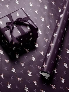 a present wrapped in purple ribbon and wrapping paper