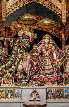 an idol is displayed in the middle of a stage with two women dressed as hindu deities