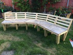 a wooden bench sitting on top of a lush green field