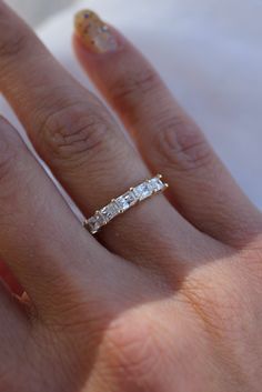 a woman's hand with a diamond ring on it