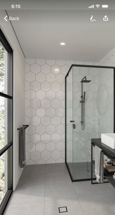 a bathroom with a walk in shower next to a sink