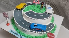 a birthday cake with cars and traffic signs on it