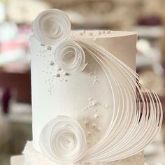 a wedding cake with white icing and flowers on it