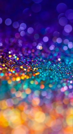 an abstract background with colorful lights and blurry bokets in blue, yellow, pink, purple and green colors