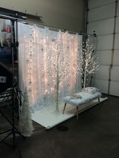 a photo studio with white lights and christmas decorations