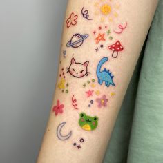 a person with a tattoo on their arm that has many different animals and stars all over it