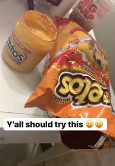 a bag of food sitting on top of a counter next to a bottle of orange juice