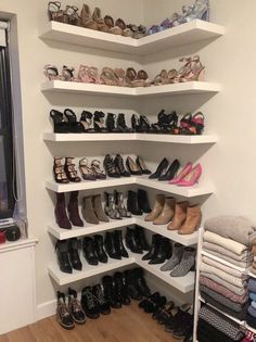 there are many pairs of shoes on the shelves