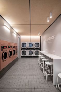 a laundry room with washers and dryers in the wall next to each other